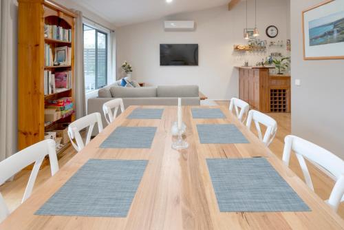 a dining room with a long wooden table and chairs at Kanangra Place, Yarra Valley in Woori Yallock