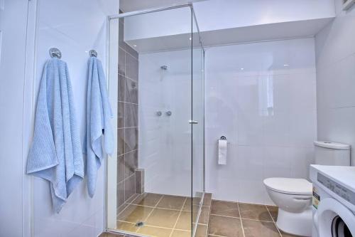 a bathroom with a shower and a toilet at Calvary Corner - Contemporary 2 Bdrm North Adelaide in North Adelaide