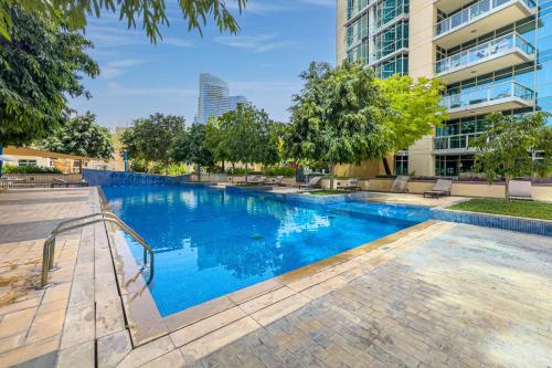 a swimming pool with blue water in a building at Savis Homes - Luxury 2 Bedroom Suite with Full Burj Khalifa View in Dubai