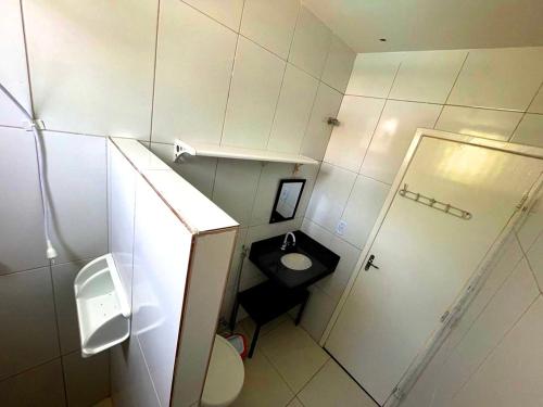 a small bathroom with a toilet and a sink at Casa da Orla - Piscina, Churrasqueira, 4 minutos da Orla Pôr do Sol in Aracaju