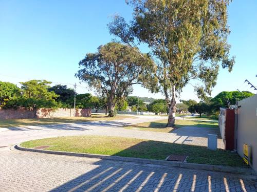 a park with a tree and a brick road at Brizzy's Garden Luxe Retreat Great Location! in Gqeberha