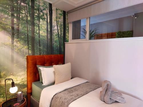 a bedroom with a bed in front of a window at Brizzy's Garden Luxe Retreat Great Location! in Gqeberha