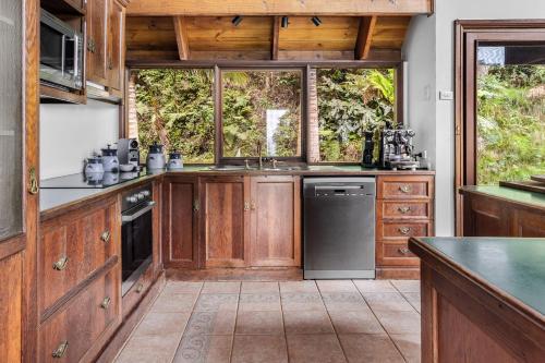 a kitchen with wooden cabinets and a counter top at Stunning Cabin Retreat By The Sea in Scarborough