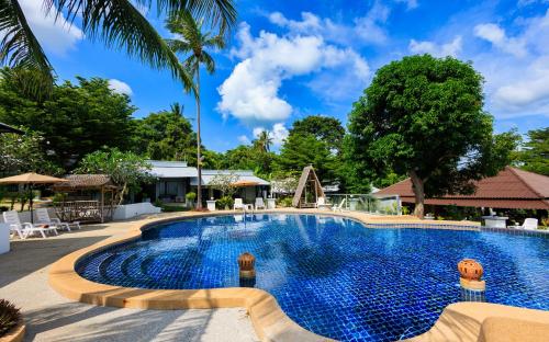 a swimming pool at a resort with a playground at Peace Garden Resort, Koh Samui in Bangrak Beach