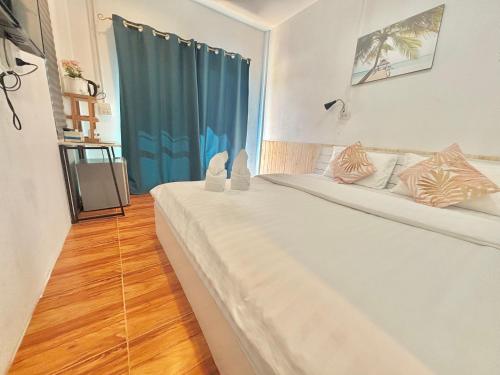 Postel nebo postele na pokoji v ubytování บ้านหมอบิวรีสอร์ทเชียงคาน BaanmhorbiwResortChiangKhan