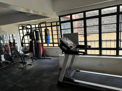 a gym with several treadmills and a treadmill at karibu homes, epic brownstone phase 1 in Nairobi