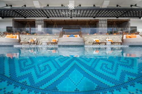 a large swimming pool with chairs in a building at Mandala Hotel & Spa Phú Yên - 24hours Stay in Tuy Hoa