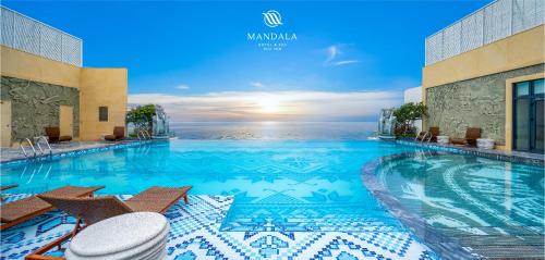 a large swimming pool with a view of the ocean at Mandala Hotel & Spa Phú Yên - 24hours Stay in Tuy Hoa