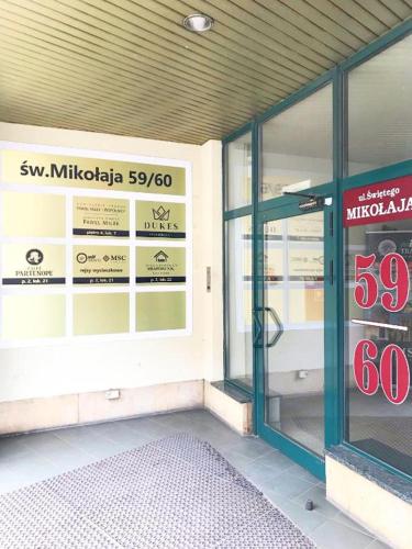 a store front with a sale sign in the window at DUKES ApartHostel - pokoje prywatne, RYNEK in Wrocław
