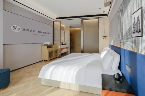 Qingdao High-tech Zone Chenfeng Hotel - Hongdao International Convention and Exhibition Center Branchにあるベッド