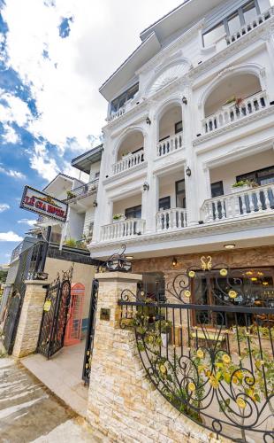 a large white building with a balcony at Le Gia Hotel in Da Lat