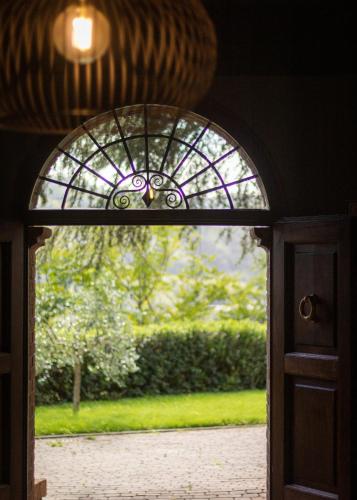 an entrance to a door with a stained glass window at Villa Naldi Relais in San Carlo