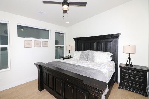 a bedroom with a large bed and a ceiling fan at Tranquil Modern Haven home in Grand Junction