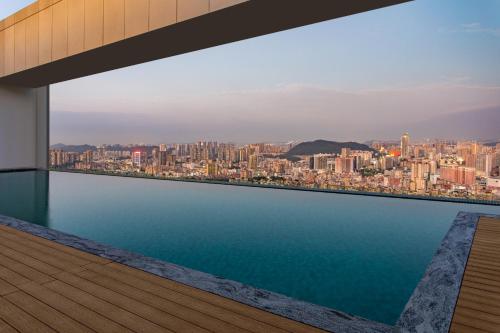 a view of the city from the balcony of a building at Ascott Fengyishan Shenzhen in Shenzhen