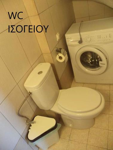 a bathroom with a white toilet and a sink at Maisonette in Paradisos 2 in Paradisos
