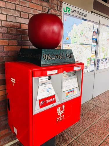 an apple sitting on top of a machine at Guest House Chara in Hirosaki