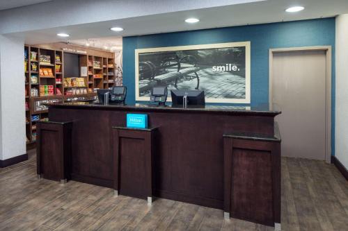 a lobby with a counter in a library at Hampton Inn & Suites Savannah - I-95 South - Gateway in Savannah
