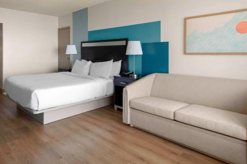 a hotel room with a bed and a couch at DoubleTree Resort by Hilton Myrtle Beach Oceanfront in Myrtle Beach