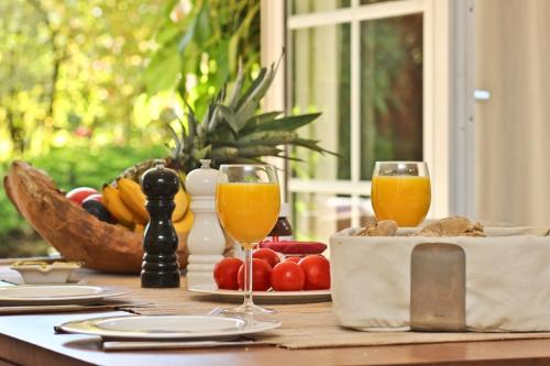 a table with two glasses of orange juice and fruit at Ferienhaus Ostseerausch in Scharbeutz