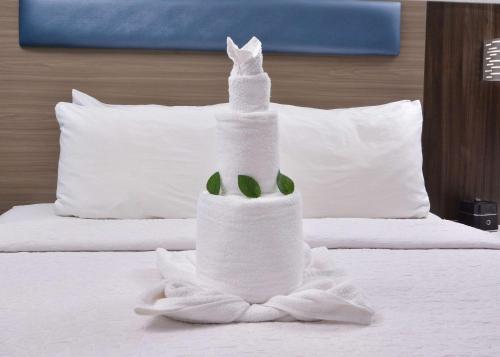 a towel shaped like a cat sitting on top of a bed at Brookstone Lodge near Biltmore Village, an Ascend Collection Hotel in Asheville