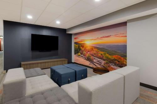 a living room with a large painting on the wall at Graystone Lodge, an Ascend Collection Hotel in Boone
