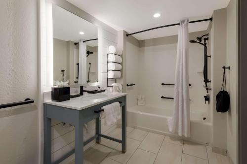 a bathroom with a sink and a shower and a tub at Graystone Lodge, an Ascend Collection Hotel in Boone