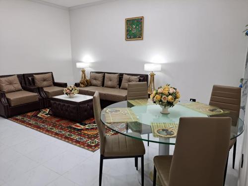 a living room with a glass table and a couch at Modern 2 bedroom & Kitchen - Prime Sukhumvit - BTS MQuartier Phrom Phong in Bangkok