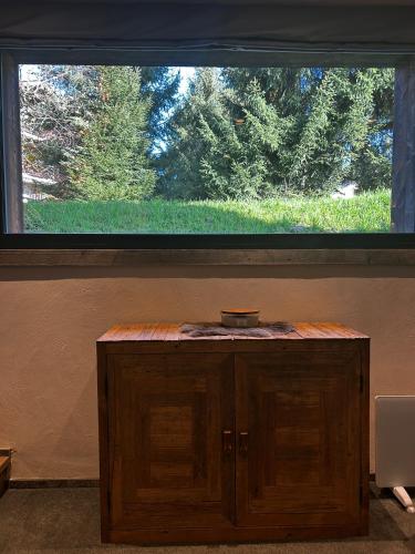 a large window above a wooden cabinet in a room at Chalet Esquinade 4 bedrooms appartment Megève in Megève