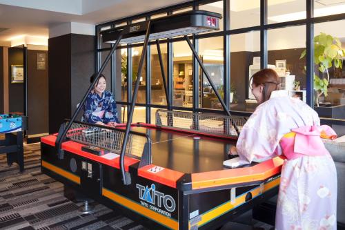 a woman standing next to a table in a store at Hita Onsen Kizantei Hotel in Hita