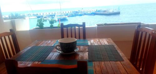 a wooden table with a coffee cup on top of it at Buena pesca 7 in Puerto del Carmen