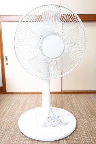 a white fan sitting on top of a floor at カプリス豊平公園305 in Sapporo