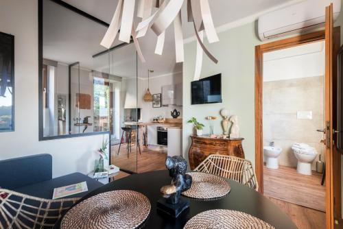 a living room with a table and chairs at SopraBosco Calcata Art & Design Apartment in Calcata