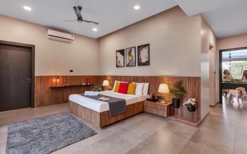 a bedroom with a large bed and a dog at SaffronStays Earl Grey in Khandala