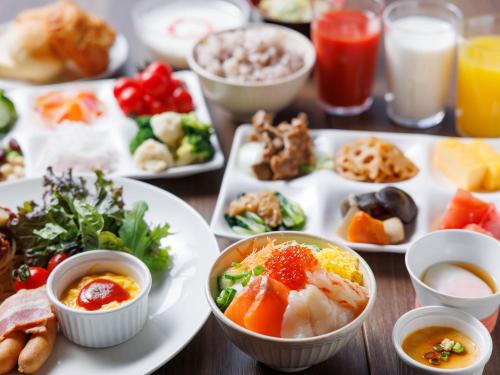 a table full of plates of food with different foods at Granbell hotel Tanuki, Sapporo in Sapporo