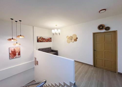 a hallway with a door and a chair in a room at Sleeping Shine de Budget พักได้ 2-3 ท่าน in Satun