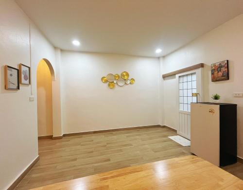 an empty living room with a refrigerator and a window at Sleeping Shine de Budget พักได้ 2-3 ท่าน in Satun