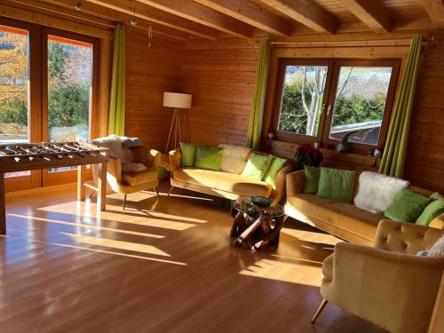 a living room with couches and a table and windows at Skigebiete Stuhleck und Semmering,Wandergebiete Schneeberg und Rax in Neunkirchen