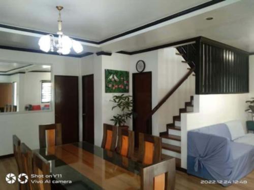 a living room with a bed and a staircase at casa lilia in Tagaytay