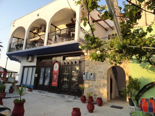 a building with a balcony on top of it at Captain's Beach Apartments in Limenas