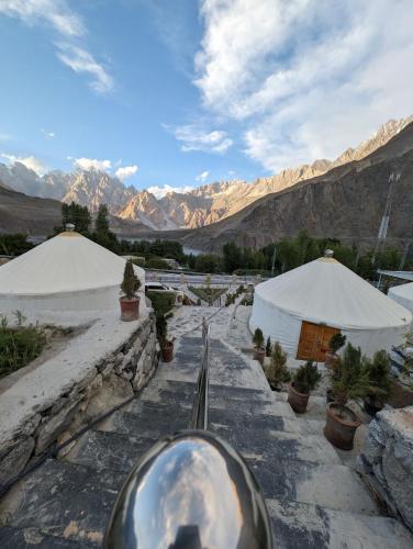 a silver ball on a stone path with mountains in the background at Apex Hotels and Resorts Hussaini in Hunza