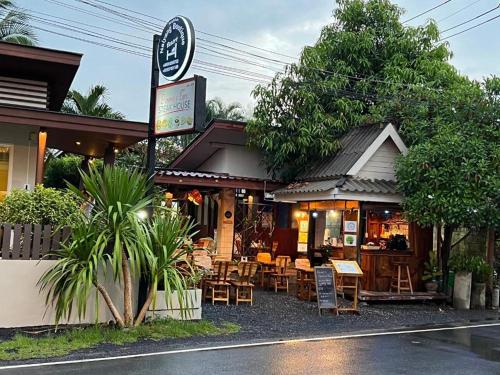 a restaurant with tables and chairs in front of it at Naiyang Boutique Resort in Ban Phak Chit
