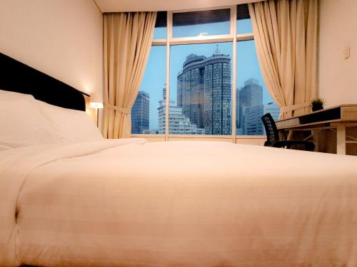 a hotel room with a large bed and a window at Vortex klcc by hr in Kuala Lumpur