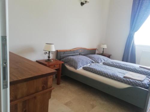 a bedroom with two beds and a wooden dresser at Penzion Zámek Rozsochatec in Rozsochatec