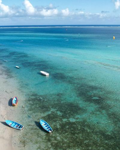 a group of boats in the water on a beach at Ô Bercail du Sud chez Jeannette in Rodrigues Island