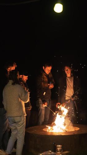 a group of people standing around a fire pit at Daft Hotel in Malmedy