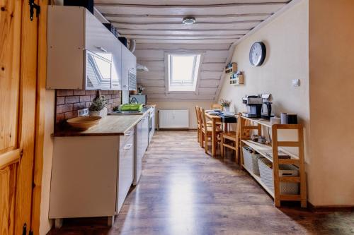 a small kitchen with a counter and a table at Rodzinny zakątek "U Głuszków" Bieszczady in Myczkowce