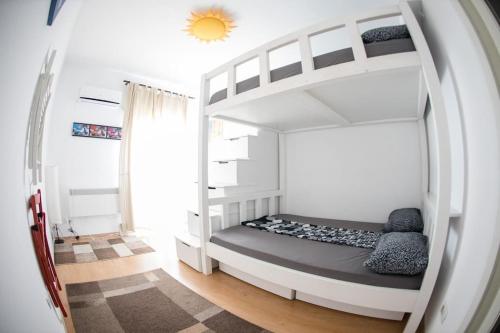 a bedroom with a bunk bed in a white room at Atheneum Star Residence in Bucharest