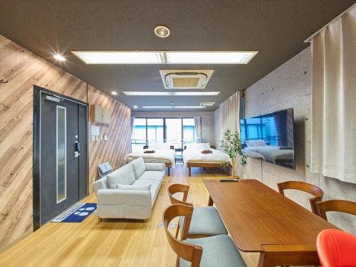 a living room with a couch and a table at Shimbashi Hotel Sho in Tokyo