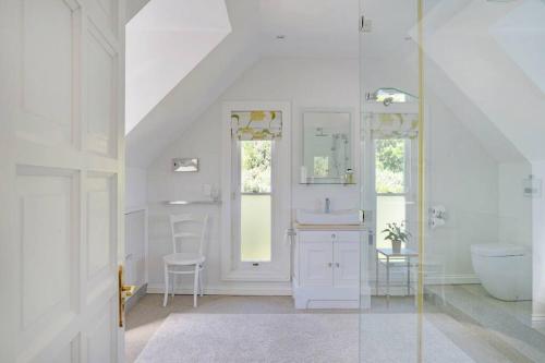 a white bathroom with a sink and a toilet at Farm Lorraine The Loft Cottage in Franschhoek