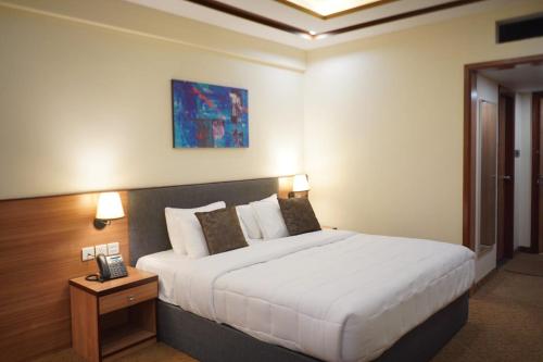 a bedroom with a large bed in a hotel room at Fortune One Hotel in Hunza